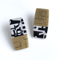 Gold and black polymer typography earrings. Jane Pellicciotto