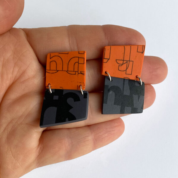 Hinged typography earrings. Polymer clay, ink toner. Jane Pellicciotto