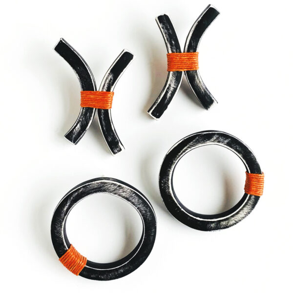 Black and white polymer clay Xs and Os with orange thread accent. Jane Pellicciotto