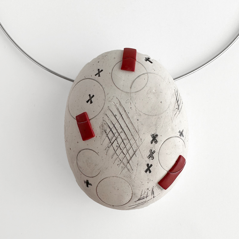 Hollow form polymer clay pendant formed over a river stone. Jane Pellicciotto