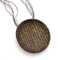 Textured disc pendant. Polymer clay and hemp cord. Jane Pellicciotto